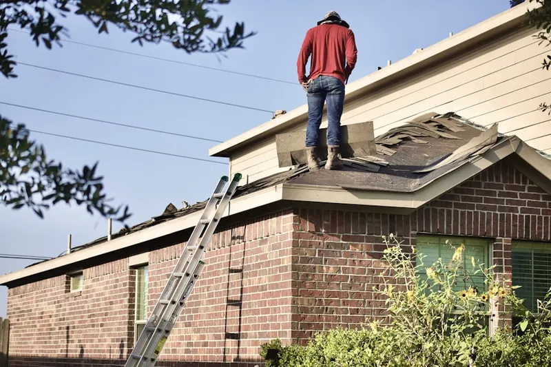 Professional roofer working on a residential roof in New Germantown